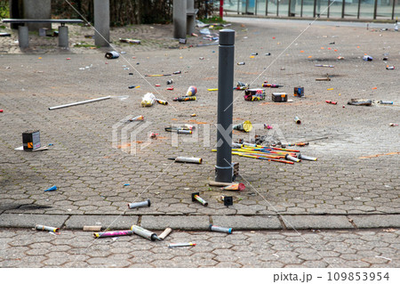 Fireworks rocket launcher box trash remains on german city street after Silvester party traditional celebration. Spoiled firecrackers waste rubbish european Germany town sidewalk Christmas New year 109853954