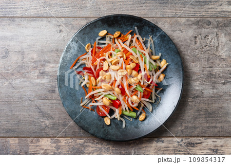 Green Papaya Salad, som tam thai on wooden table. Green Papaya Salad, som tam thai on wooden table. 109854317