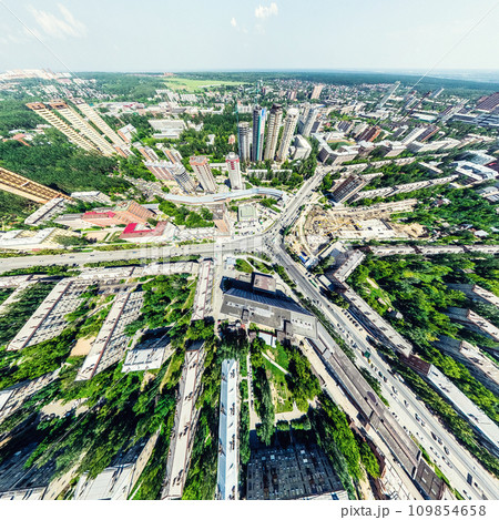 Aerial city view with crossroads and roads, houses, buildings, parks and parking lots. Sunny summer panoramic image Aerial city view with crossroads and roads, houses, buildings, parks and parking lots. Sunny summer panoramic image 109854658