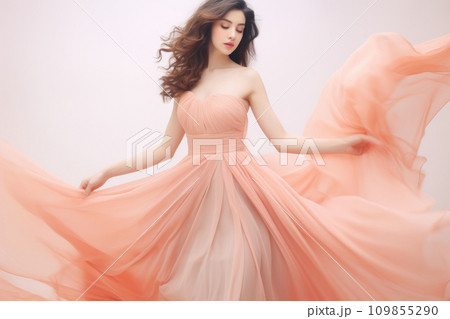 Beautiful young woman in evening dress peach fuzz color of the year 2024 109855290