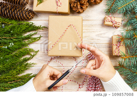 Process of packing boxes with Christmas gifts presents. Top view 109857008