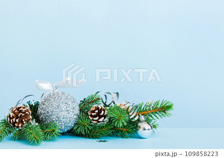 New Year Christmas tree toy, branches of a christmas tree, New Year decorations on a colored background 109858223