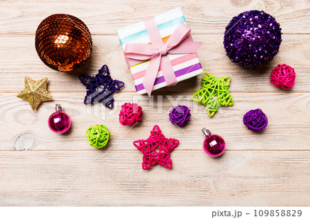 Top view Christmas ball, gift and creative decorations on wooden background. New Year holiday concept with copy space 109858829