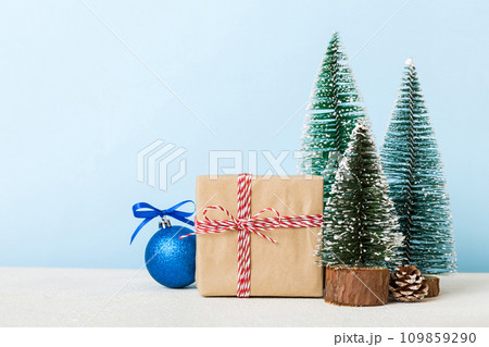 Christmas composition. Gifts, small tree, branches and craft DIY decorations on white background. New year concept. Christmas home decoration Flat lay, top view, copy space 109859290