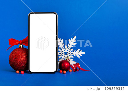 Digital phone mock up with rustic Christmas decorations for app presentation with empty space for you design. Christmas online shopping concept. Tablet with copy space on colored background 109859313