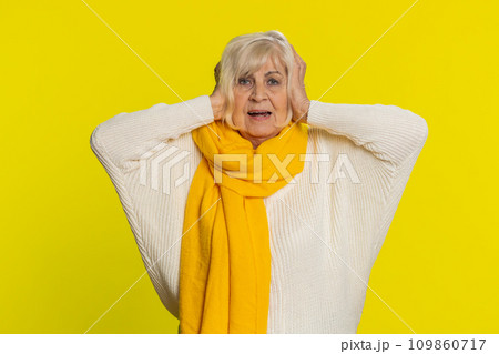 Annoyed irritated senior woman covering ears gesturing no avoiding advice ignoring noise loud voices 109860717