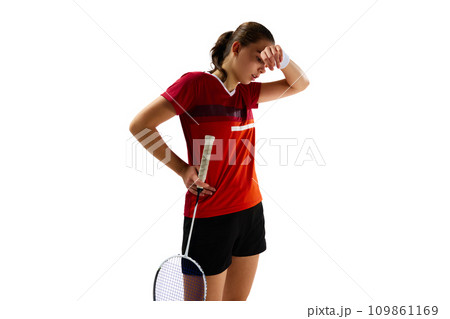 Portrait of young girl, professional badminton player have a rest between times against white studio background. 109861169