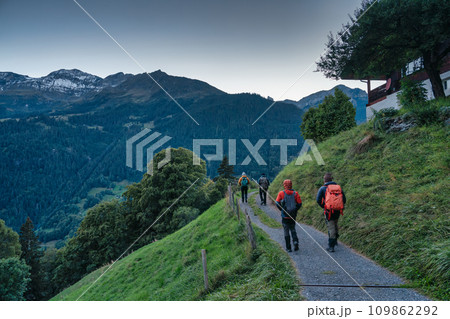 Group of backpacker hiking on trail in Swiss Alps valley on summit 109862292