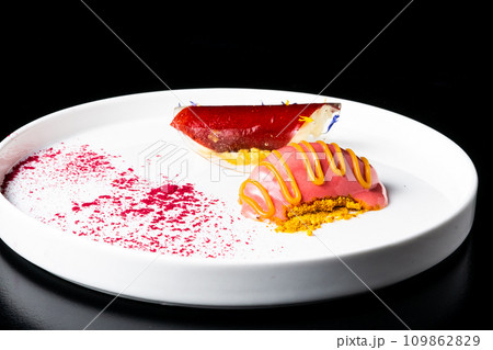 Italian Sicilian cannolo dessert closeup on white plate macro with crust and ricotta cheese Italian Sicilian cannolo dessert closeup on white plate macro with crust and ricotta cheese 109862829