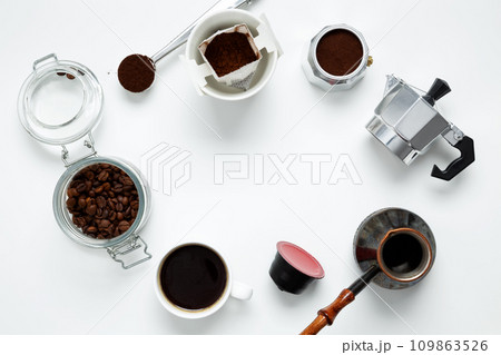Ingredients for making coffee. Different ways to make coffee geyser moka maker, metal cezve, coffee machine capsules, drip. Coffee making concept. Flat Lay. Top view. Copy space Ingredients for making coffee. Different ways to make coffee geyser moka maker, metal cezve, coffee machine capsules, drip. Coffee making concept. Flat Lay. Top view. Copy space 109863526