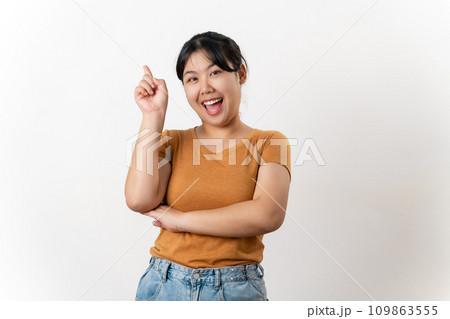The cheerful young Asian woman has great thought, finding inspiration or solutions to solve a problem. pointing finger up standing on white background. 109863555