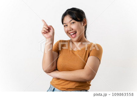 The cheerful young Asian woman has great thought, finding inspiration or solutions to solve a problem. pointing finger up standing on white background. The cheerful young Asian woman has great thought, finding inspiration or solutions to solve a problem. pointing finger up standing on white background. 109863558