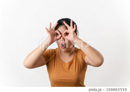 The pretty Asian young woman with surprise and shocked facial expression standing on a white background. 109863559
