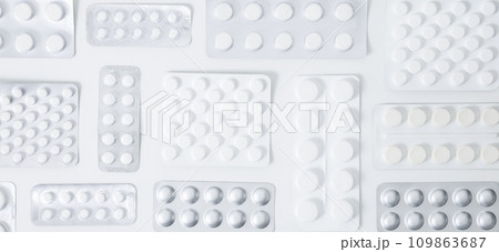 Various tablets and capsules in blisters on white background. Concept of healthcare and medicine. Top view Various tablets and capsules in blisters on white background. Concept of healthcare and medicine. Top view 109863687
