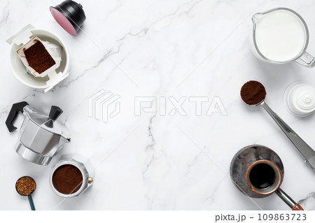 Ingredients for making coffee. Different ways to make coffee geyser moka maker,  metal cezve, coffee machine capsules, drip. Coffee making concept. Flat Lay. Top view. Copy space 109863723