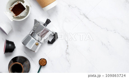 Ingredients for making coffee. Different ways to make coffee geyser moka maker,  metal cezve, coffee machine capsules, drip. Coffee making concept. Flat Lay. Top view. Copy space 109863724
