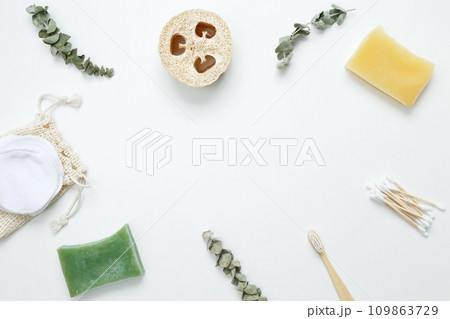 Natural organic eco cosmetics. Soap Eco, reusable cotton pads, loofah natural sponge washcloth, cotton swab, eucalyptus leaves on white background. Flat lay, top view, copy space Natural organic eco cosmetics. Soap Eco, reusable cotton pads, loofah natural sponge washcloth, cotton swab, eucalyptus leaves on white background. Flat lay, top view, copy space 109863729