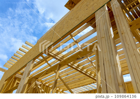 Beams framed in wooden framework under construction of new house 109864136