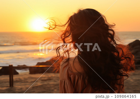 AI-generated content. A girl with flying wavy hair looks at the sunset on the sea 109864165