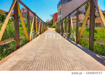 A metal pedestrian bridge connecting the two sides A metal pedestrian bridge connecting the two sides 109864557