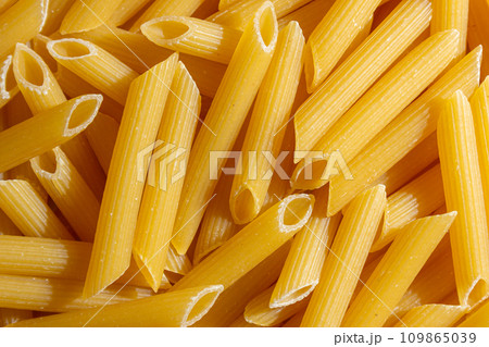 Uncooked Penne Rigate Pasta Background 109865039