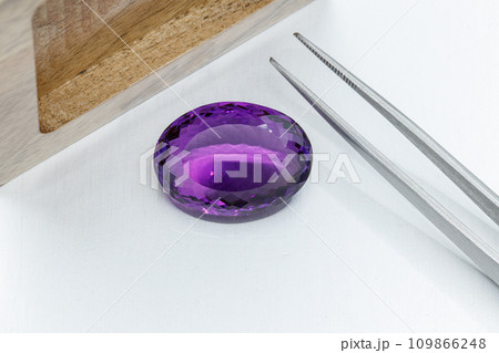 macro mineral faceted stone cut Amethysts on a gray background macro mineral faceted stone cut Amethysts on a gray background 109866248