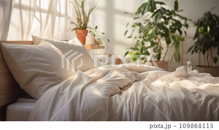 the bed has white linens and a lamp 109868113