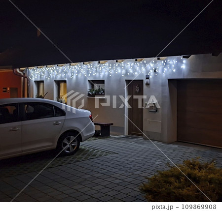 Festive Christmas lFestive Christmas lighting of the house. Holiday Christmas lights on the house in winter. House illumination during Christmas and New Year 109869908