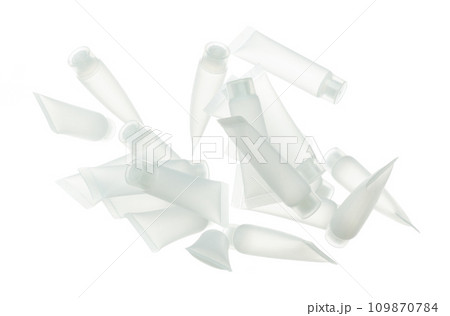 Cosmetic container white bottle fly splashing. Tube transparent in mid air. Many Moisturizer lotion cream bottle explosion flying many angle. White background isolated high speed shutter freeze motion 109870784