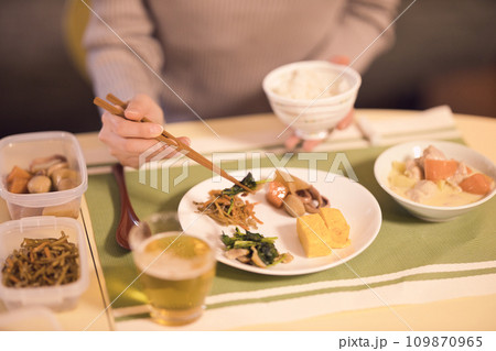 作り置きのお料理で夕食をとるビジネスウーマンの手元　ナイトルーティーン 109870965