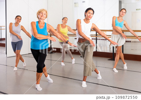 Modern active females dancing excited posing in studio Modern active females dancing excited posing in studio 109872550