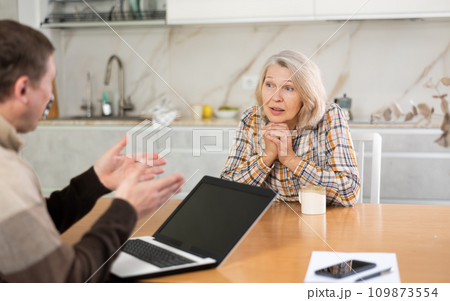 Old woman considering offer from agent 109873554