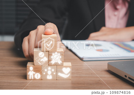 Credibility concept, Business woman hand holding wooden block on office desk with credibility icon on virtual screen. Credibility concept, Business woman hand holding wooden block on office desk with credibility icon on virtual screen. 109874816