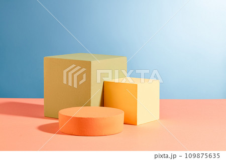 Three podiums in round and cube shaped are decorated against blue background. Pastel minimal wall scene collection. Modern platform for product display presentation Three podiums in round and cube shaped are decorated against blue background. Pastel minimal wall scene collection. Modern platform for product display presentation 109875635