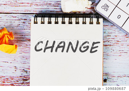 CHANGE word written on a sheet of notebook lying on old vintage boards with a calculator and folded paper CHANGE word written on a sheet of notebook lying on old vintage boards with a calculator and folded paper 109880687