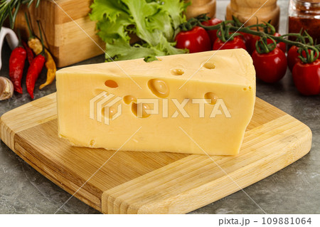 Swiss Maasdam cheese triangle over board Swiss Maasdam cheese triangle over board 109881064