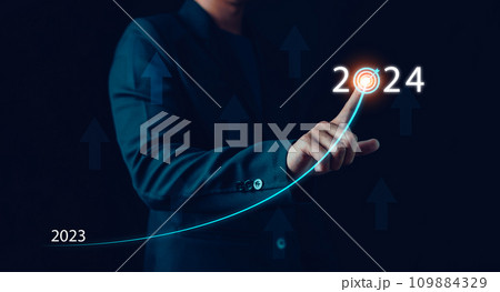 Businessman hand draws line for increasing arrow from 2023 to 2024, New goals, Plans and visions for next year 2024, Preparation merry Christmas and happy new year concept. new business. 109884329