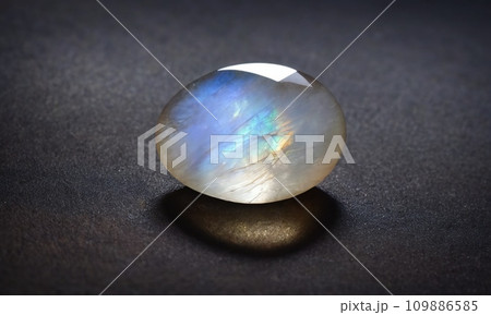 Natural precious moonstone on a gray background. Natural stone adularia 109886585