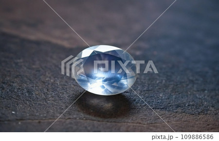 Natural precious moonstone on a gray background. Natural stone adularia 109886586
