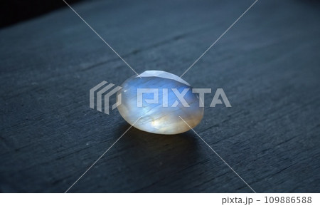 Natural precious moonstone on a gray background. Natural stone adularia 109886588