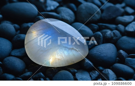 Natural precious moonstone on a gray background. Natural stone adularia 109886600
