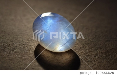 Natural precious moonstone on a brown background. Natural stone adularia 109886626