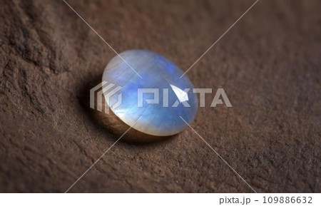 Natural precious moonstone on a brown background. Natural stone adularia 109886632