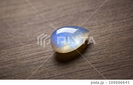Natural precious moonstone on a brown background. Natural stone adularia 109886645