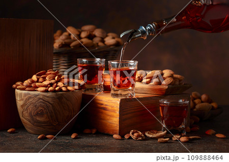 Italian liqueur Amaretto with almonds nuts. Italian liqueur Amaretto with almonds nuts. 109888464