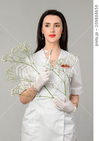 the girl holds two brushes in her hands on a white background the girl holds two brushes in her hands on a white background 109888650