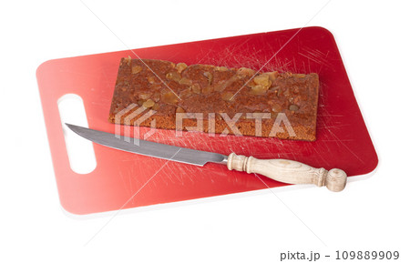 Traditional gingerbread cake on a red gradient cutting board, isolated on white 109889909