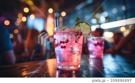 people in a party drinking glasses of sangria in background with colorful lights 109890897