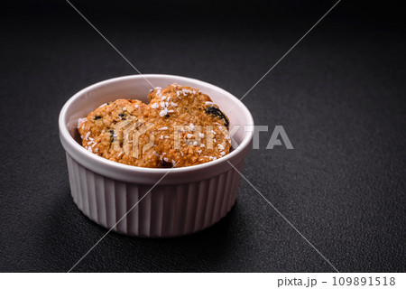 Delicious sweet round sponge cookies sprinkled with coconut flakes Delicious sweet round sponge cookies sprinkled with coconut flakes 109891518