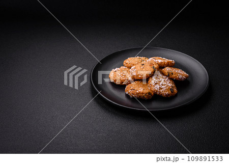 Delicious sweet round sponge cookies sprinkled with coconut flakes Delicious sweet round sponge cookies sprinkled with coconut flakes 109891533